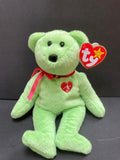 Green beanie baby teddy bear with red bow and signature heart on his chest