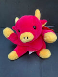 Pink bull beanie baby with yellow snout and feet