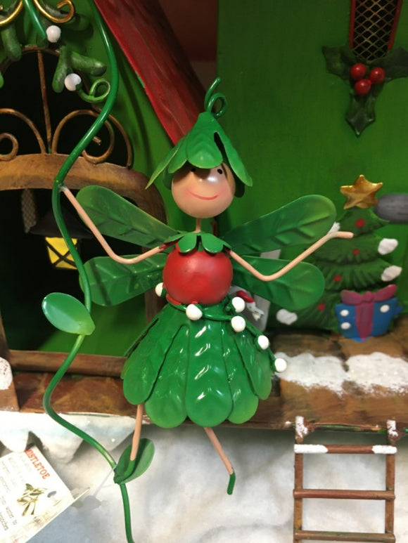 metal fairy decorated in mistletoe 