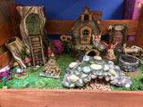 Fairy garden with pebbled well and bridge