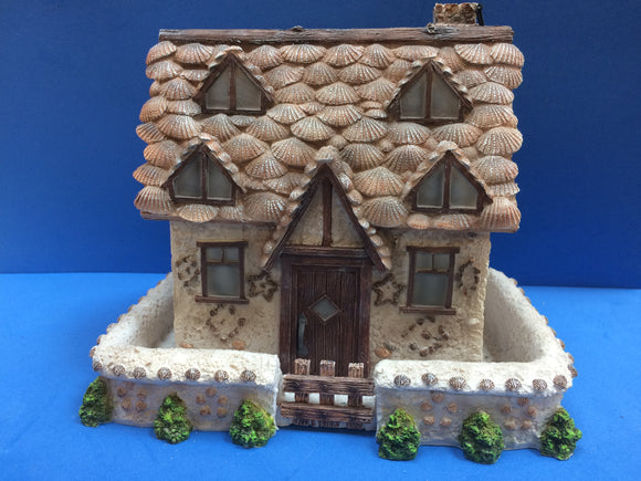 Pretty fairy house decorated with ceramic shells