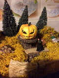 Spooky pumpkin in a cauldron garden