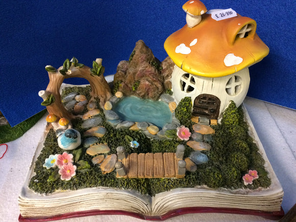 ceramic fairy scene displayed on fairy tale book
