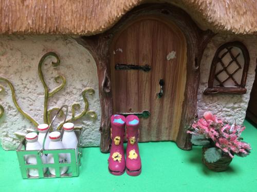 Fairy home with delivered milk and wellies outside
