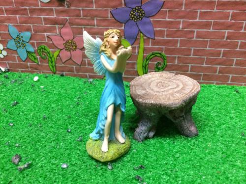 Standing ceramic fairy in blue dress
