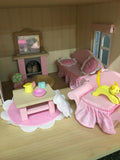 pink wooden dolls house living room