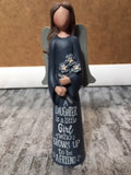 Angel ornament in a blue dress holding flowers