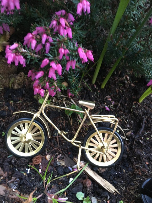 Miniature bicycle under real flowers