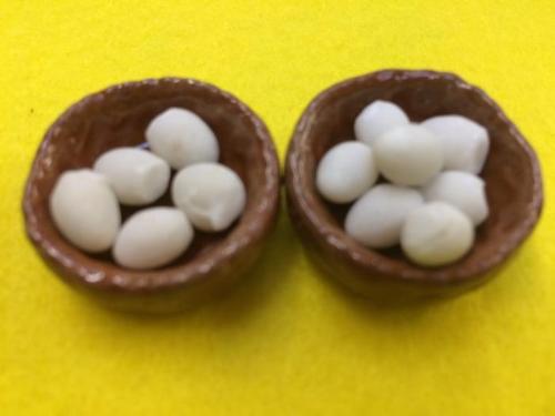 miniature ceramic eggs in baskets