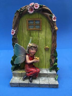 fairy door with fairy sitting on steps