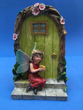 fairy door with fairy sitting on steps