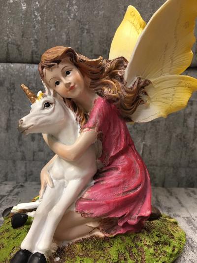 Fairy hugging unicorn figurine