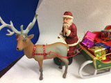 Reindeer and sled with presents and Santa