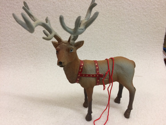 Miniature reindeer with harness for sled
