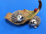 Two hedgehogs on a leaf ornament